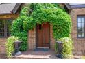Inviting front door with lush ivy and decorative urns, creating a welcoming entrance at 418 3Rd Ne St, Hickory, NC 28601