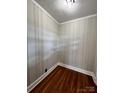Corner of a room showcasing hardwood floors, paneled walls, and detailed trim work, adding classic charm at 511 W Main St, Cleveland, NC 27013