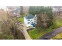 Aerial view of a well-maintained two story home with lush landscaping and a long driveway at 5680 Gold Creek Bay None, Hickory, NC 28601