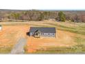 Expansive view of new construction home with gray siding, dark roof, and a covered front porch, set on a spacious lot at 629 Mt. Wesley Church Rd, Hiddenite, NC 28636