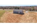 An aerial view showcases the home's new gray siding, dark roof, back entrance and spacious lot ready for landscaping at 629 Mt. Wesley Church Rd, Hiddenite, NC 28636