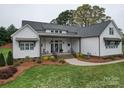 Charming home exterior with covered porch, green lawn, and landscaped garden at 630 Deese Rd, Monroe, NC 28110