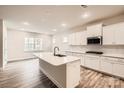 Modern kitchen with white cabinets, a center island, stainless steel appliances, and recessed lighting at 7009 New Town Rd, Waxhaw, NC 28173