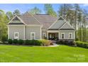 Beautiful one story home boasts professionally landscaped yard with manicured lawn and hedges at 125 Trent Pines Dr, Mooresville, NC 28117