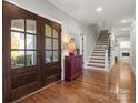 Welcoming foyer featuring hardwood floors, staircase, and view into other rooms at 125 Trent Pines Dr, Mooresville, NC 28117