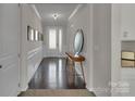 Elegant hallway with hardwood floors, decorative molding, and ample natural light at 128 Stibbs Cross Rd, Mooresville, NC 28115