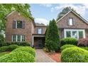 Charming brick home with manicured landscaping, stone walkway, and beautiful curb appeal at 13620 Castleford Dr, Mint Hill, NC 28227
