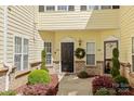 Inviting entrance with black front door, lush landscaping, and brick accents for a warm welcome at 1386 21St Ne Ave, Hickory, NC 28601