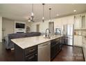 Open-concept kitchen with stainless appliances, island, and hardwood floors flowing to living area at 1495 Imperial Ct, York, SC 29745