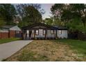 Charming bungalow with a covered porch, black trim, and freshly painted white brick at 1812 Lot 2 Anderson St, Charlotte, NC 28205