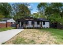 Charming bungalow with a covered porch, black trim, and freshly painted white brick at 1812 Lot 2 Anderson St, Charlotte, NC 28205