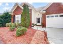 Charming brick home with manicured lawn, shrubbery, and a two-car garage at 2020 Makin Dr, Indian Trail, NC 28079