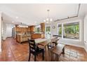 Open-concept kitchen with dining area, tile floors, and plenty of natural light at 21 Hollyberry Woods, Lake Wylie, SC 29710