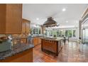 Spacious kitchen features a professional range, custom cabinets, and views of the backyard at 21 Hollyberry Woods, Lake Wylie, SC 29710