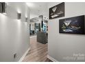 Hallway featuring modern lighting fixtures and decorative artwork creating an inviting entrance at 210 N Church St # 1307, Charlotte, NC 28202
