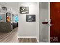 Condo hallway with artwork leading into the kitchen area, showcasing the modern design at 210 N Church St # 1307, Charlotte, NC 28202
