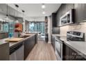 Contemporary kitchen equipped with stainless steel appliances and a view of the city skyline at 210 N Church St # 1307, Charlotte, NC 28202