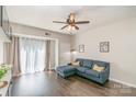 Inviting living room features a comfortable blue sectional sofa, ceiling fan and lots of natural light at 211 Heritage Blvd # 309, Fort Mill, SC 29715