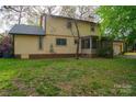 The backyard has mature trees, lush grass, and a screened in porch perfect for outdoor relaxation at 2131 Wildlife Rd, Charlotte, NC 28214