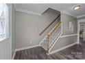 Inviting entryway with staircase, wood floors, and white trim at 2439 Heathershire Ln, Matthews, NC 28105