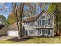Charming two-story home with gray siding, beautiful landscaping, and a well-maintained front yard offering curb appeal at 2439 Heathershire Ln, Matthews, NC 28105