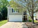 Inviting two-story home with a manicured front yard, attached garage, and covered entryway at 2752 Bramble Ridge Ct, Charlotte, NC 28215