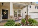 Cozy front porch with seating area, potted plants, and decorative welcome sign at 3009 Early Rise Ave, Indian Trail, NC 28079