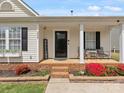 Welcoming front porch with chairs and a 