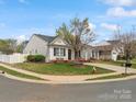 Attractive single-story home showcasing a lush green lawn, mature tree, and a welcoming front entrance at 3020 Salmon River Dr, Monroe, NC 28110