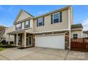 Charming two-story home with stone accents, a well-manicured lawn, and a two-car garage at 326 Nantucket Way, Rock Hill, SC 29732