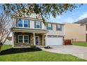 Charming two-story home with stone accents, a well-manicured lawn, and a two-car garage at 326 Nantucket Way, Rock Hill, SC 29732