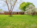 Charming brick ranch-style home with a well-manicured lawn and mature trees at 3452 Flat Creek Rd, Lancaster, SC 29720