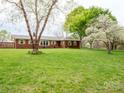 Charming brick home featuring a lush green lawn and mature trees in a serene, landscaped setting at 3452 Flat Creek Rd, Lancaster, SC 29720
