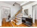 Elegant foyer showcasing hardwood floors, decorative stairway, and stylish console table with mirror at 3916 Riverbend Rd, Charlotte, NC 28210