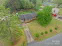 Aerial view of a house with a long driveway and mature trees in the yard at 417 Donna Ave, Gastonia, NC 28052