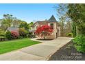 Charming home with turret, lovely landscaping, and a long driveway leading to the residence at 4300 Old Course Dr, Charlotte, NC 28277