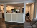 Open-concept kitchen with white cabinetry, stainless steel appliances, and seamless flow to the living space at 508 S Jackson Ave, Waxhaw, NC 28173
