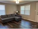 Bright living room featuring wood floors, a neutral color palette, and abundant natural light at 508 S Jackson Ave, Waxhaw, NC 28173