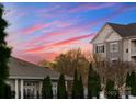 Real estate featuring well-maintained buildings, mature trees, and manicured lawns under a colorful sky at 6020 Union Pacific Ave, Charlotte, NC 28210