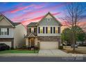 Home boasts a stone and siding exterior, complemented by black shutters and a neatly kept front lawn at 6020 Union Pacific Ave, Charlotte, NC 28210