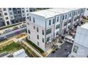 Aerial view of modern townhomes featuring balconies, a parking area, and contemporary design at 631 W Tremont Ave, Charlotte, NC 28203