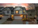Attractive townhome boasts a well-kept lawn and attached garage at 6619 Portland Rose Ln, Charlotte, NC 28210