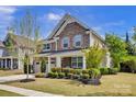 Charming two-story home showcasing a stone facade, complemented by a well-manicured lawn and neutral color palette at 704 Fresia Dr, Tega Cay, SC 29708