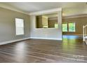 Open-concept living room boasts hardwood floors, bright windows, and neutral walls at 9419 Seamill Rd, Charlotte, NC 28278