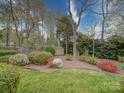 Lush backyard featuring mature trees and landscaping at 9539 Errington Ln, Mint Hill, NC 28227
