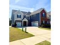 Expansive two-story home with a three-car garage and manicured lawn under a partly cloudy sky at 9677 Garamont Nw Pkwy, Concord, NC 28027