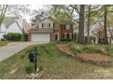 Charming two-story brick home with a well-manicured front yard and an attached two-car garage at 108 Kinderston Dr, Davidson, NC 28036