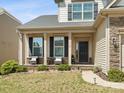 Inviting front porch with stone accents, seating, and well-maintained landscaping provides curb appeal at 110 Lantern Acres Dr, Mooresville, NC 28115