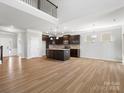 Spacious living room with an open floor plan, kitchen island, and lots of natural light at 110 Lantern Acres Dr, Mooresville, NC 28115
