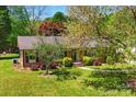 Aerial view of brick home showcasing a lush lawn and mature trees at 110 Tanglewood Dr, Kannapolis, NC 28081